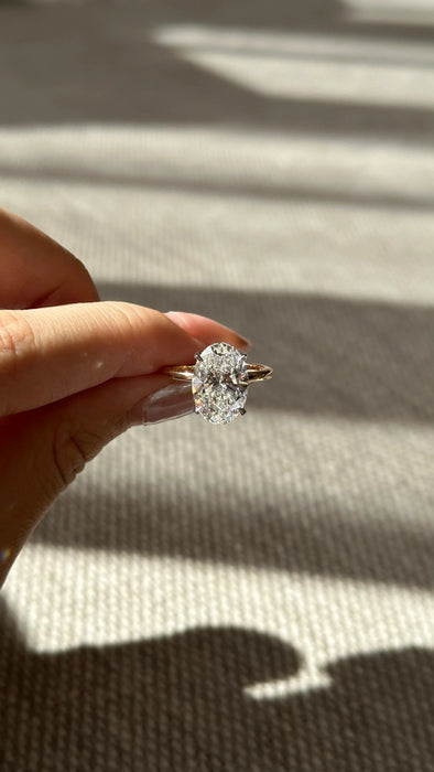 Two Tone Oval Cut Diamond Ring with Hidden Halo