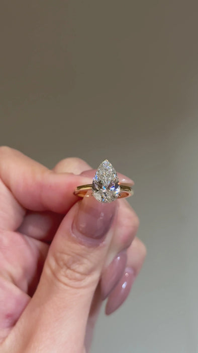 Solitaire Pear Cut Diamond Ring with Plain Band