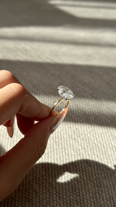 Two Tone Oval Cut Diamond Ring with Hidden Halo